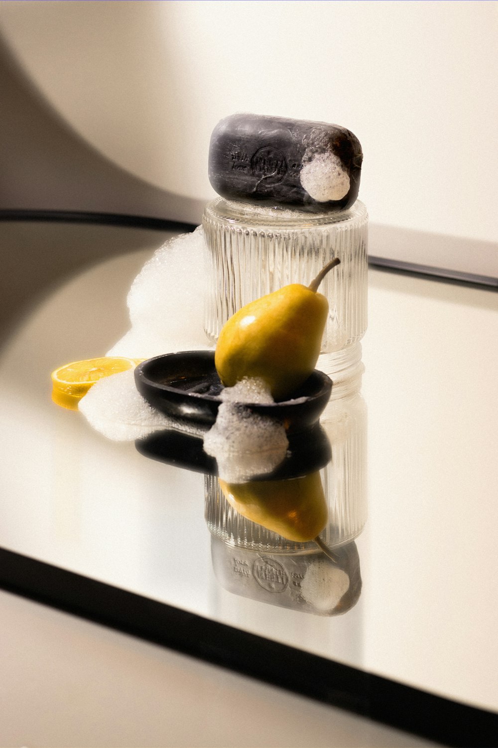 a glass table topped with a salt and pepper shaker and a pear