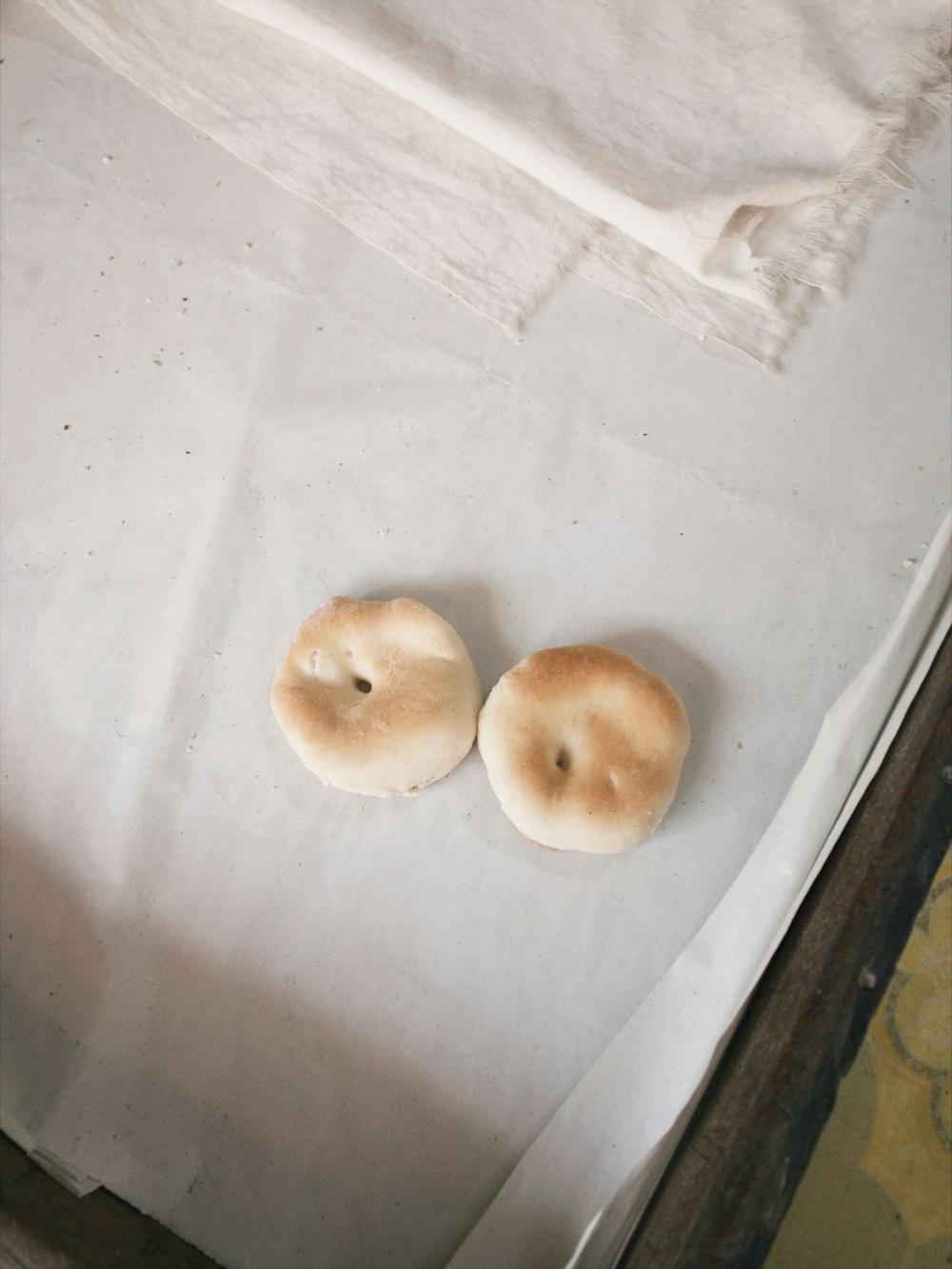 two bagels sitting on top of a piece of paper