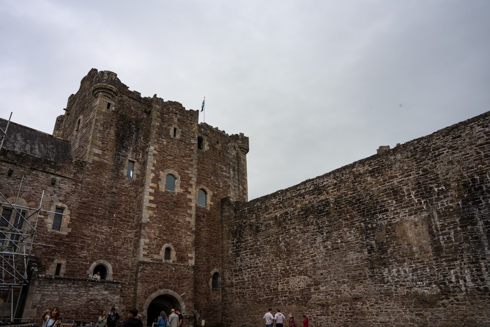 a group of people standing in front of a castle