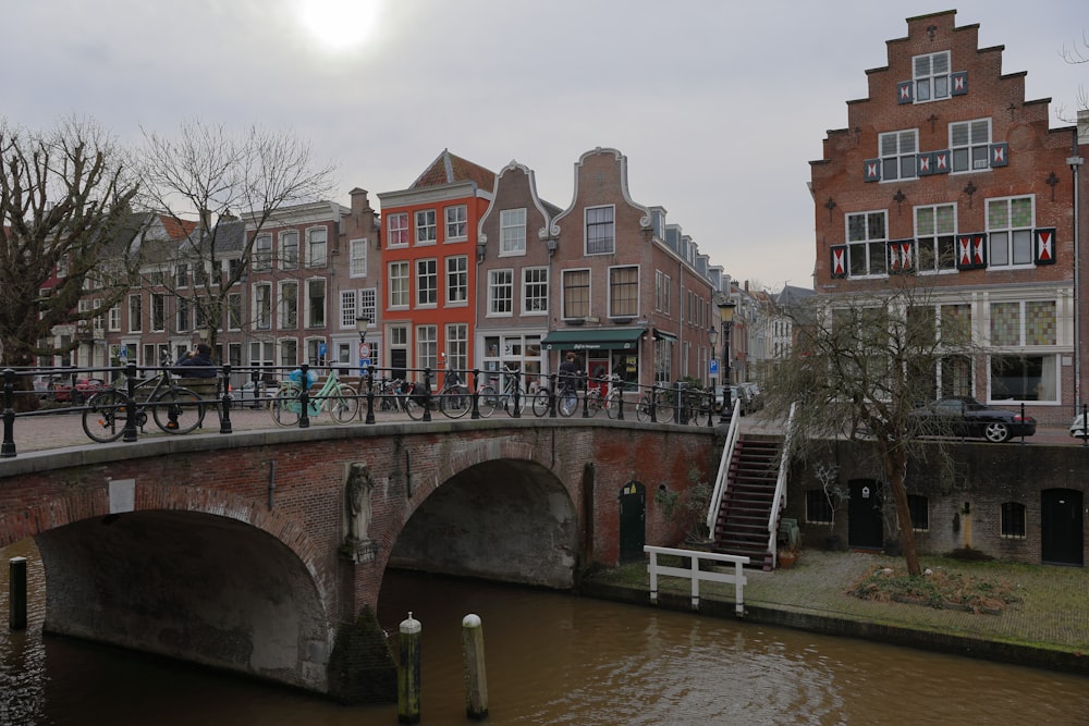 a bridge over a body of water with bicycles on it