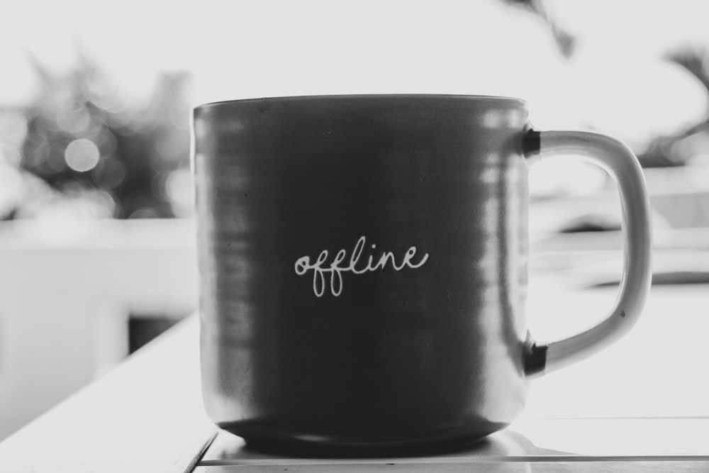 a black and white photo of a coffee mug