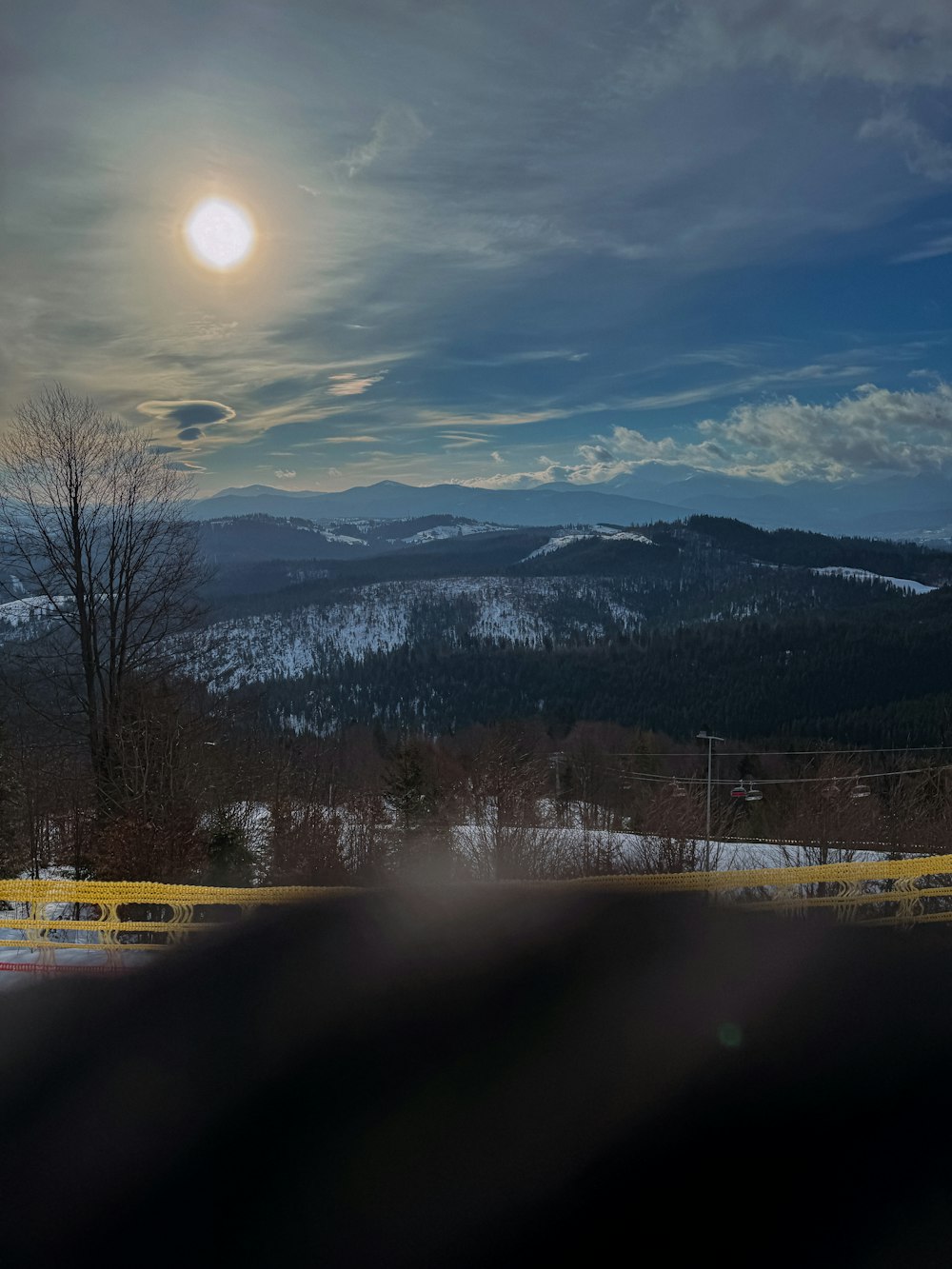 the sun is setting over the mountains in the distance