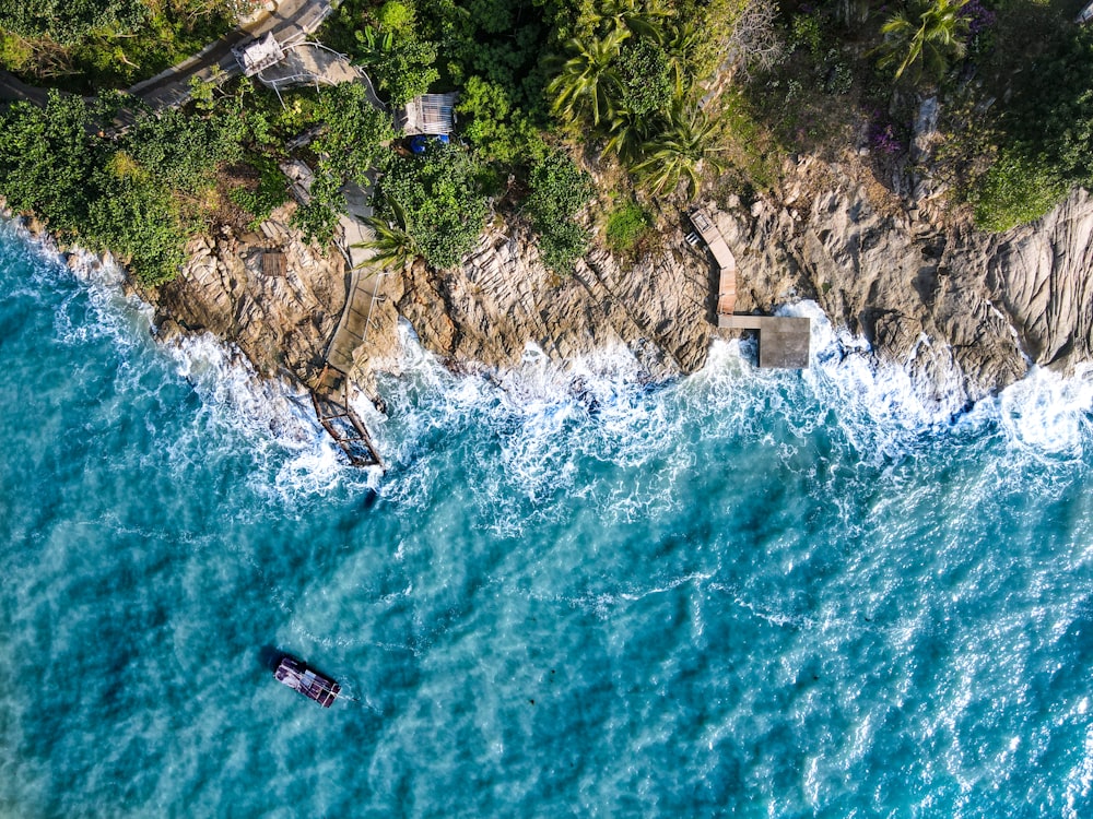 an aerial view of a boat in the ocean