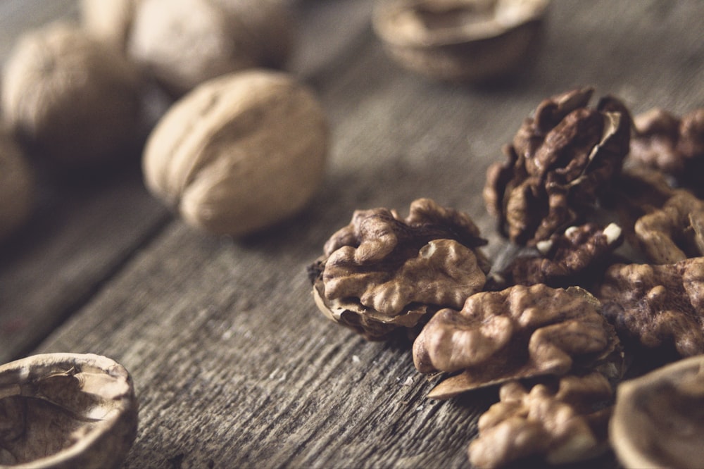 a pile of walnuts sitting on top of a wooden table