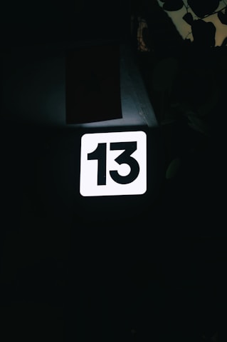 a close up of a street sign in the dark
