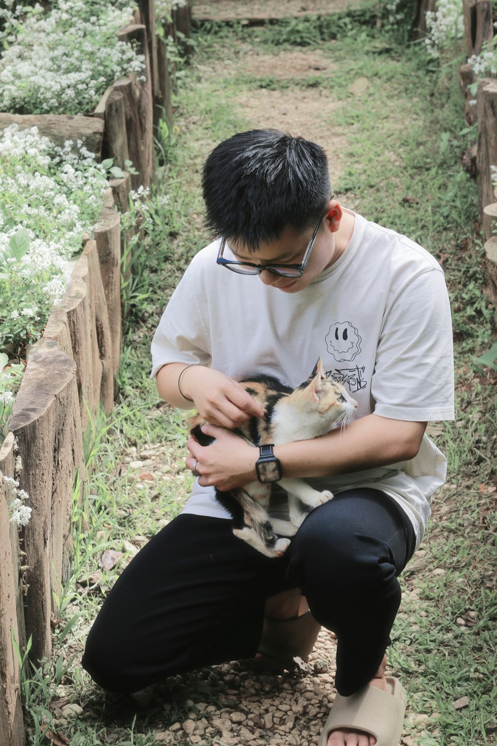 a man is holding a cat in his hands