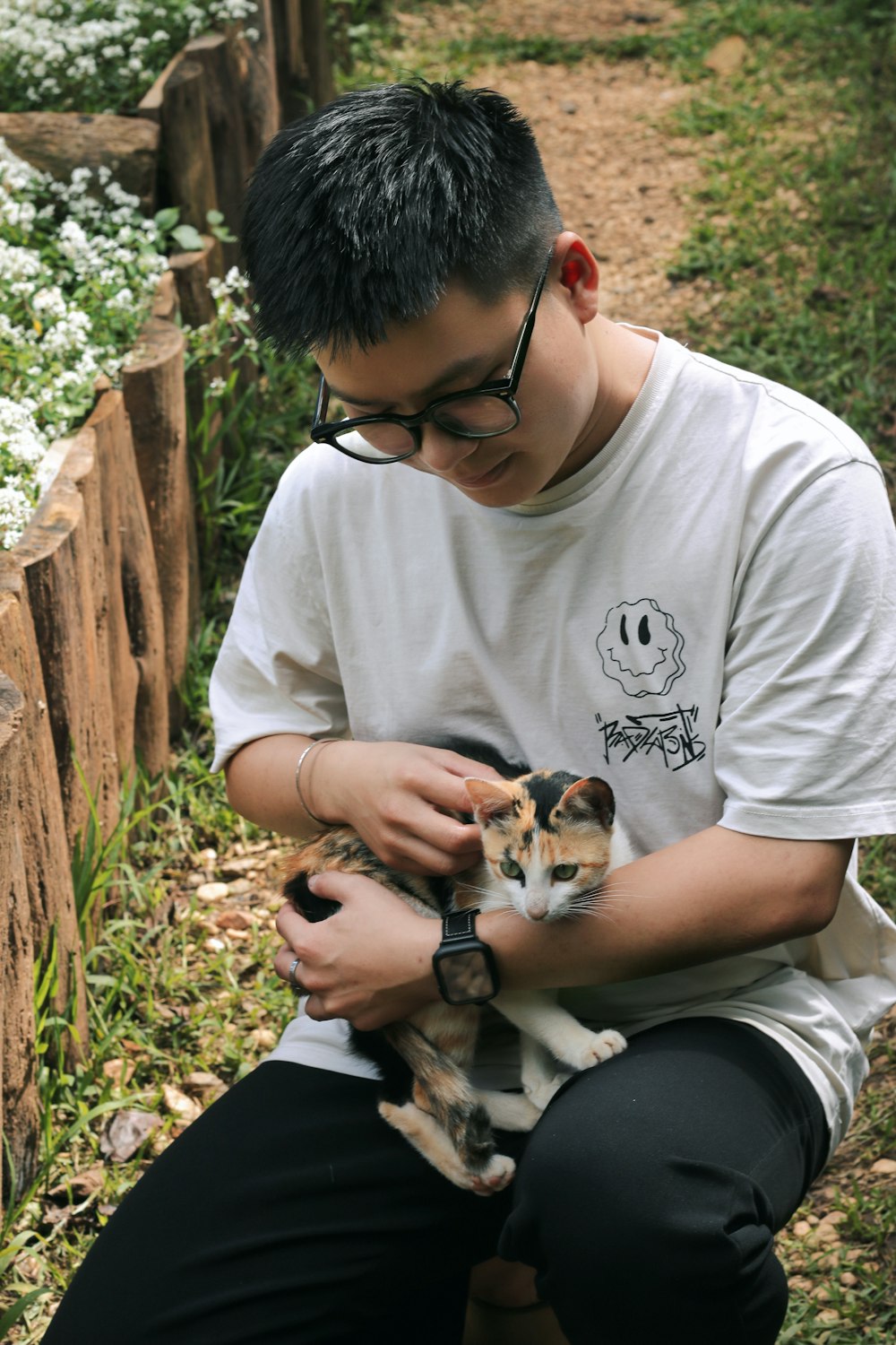 a man holding a cat in his hands