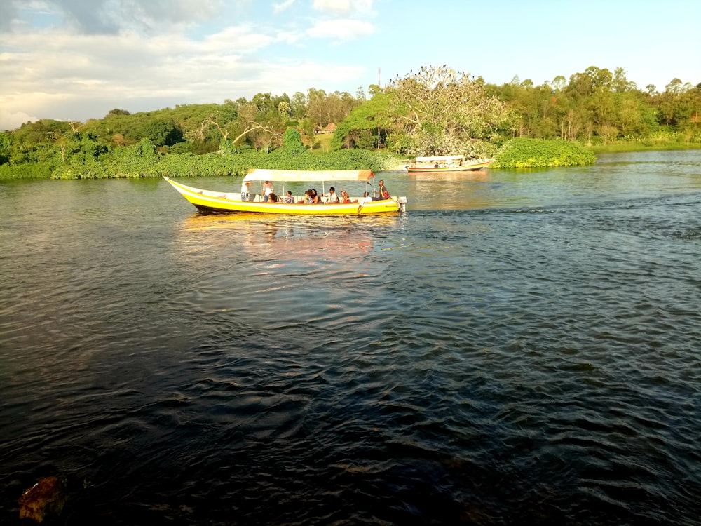 a group of people on a yellow boat on a river