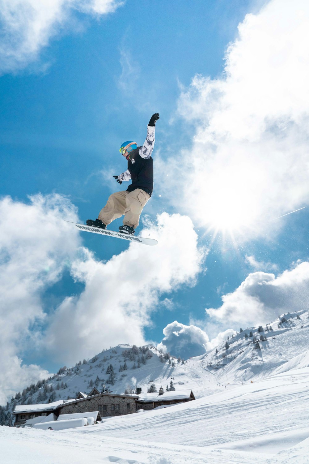 a man flying through the air while riding a snowboard