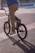 a man riding a bike down a street
