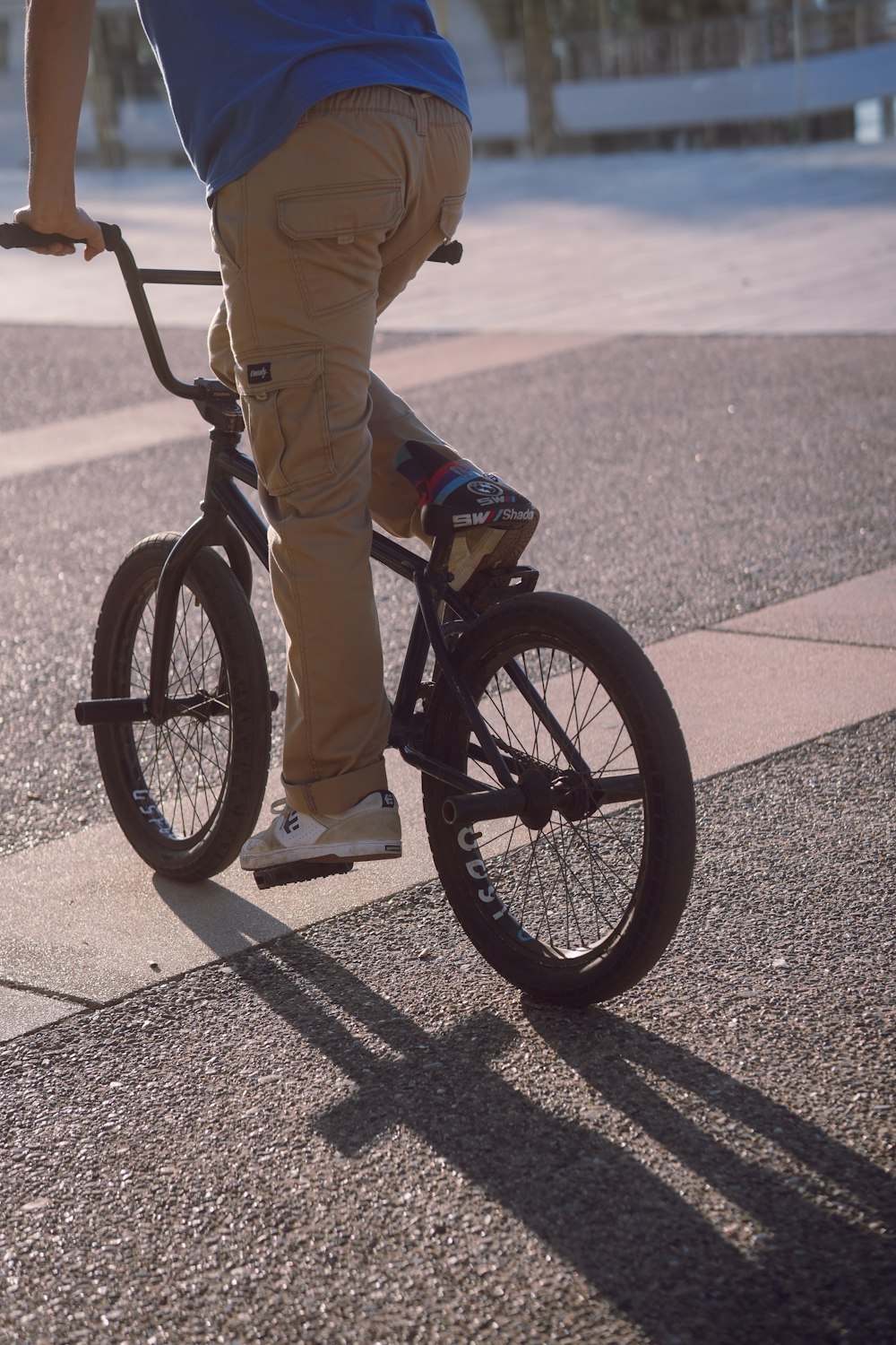 a man riding a bike down a street