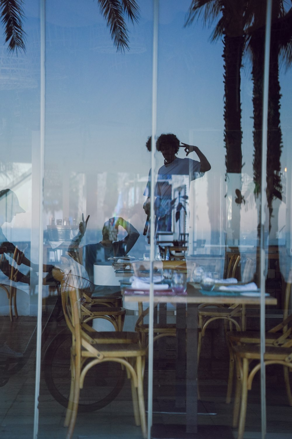 a reflection of a person sitting at a table