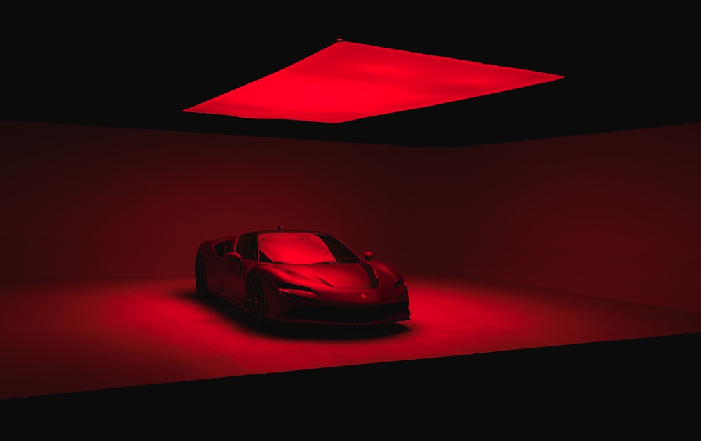 a red sports car in a dimly lit room