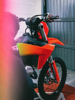 a motorcycle parked inside of a garage next to a wall