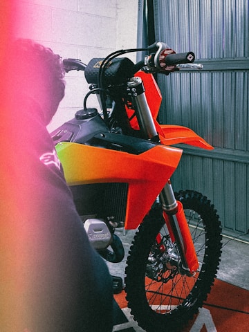 a motorcycle parked inside of a garage next to a wall
