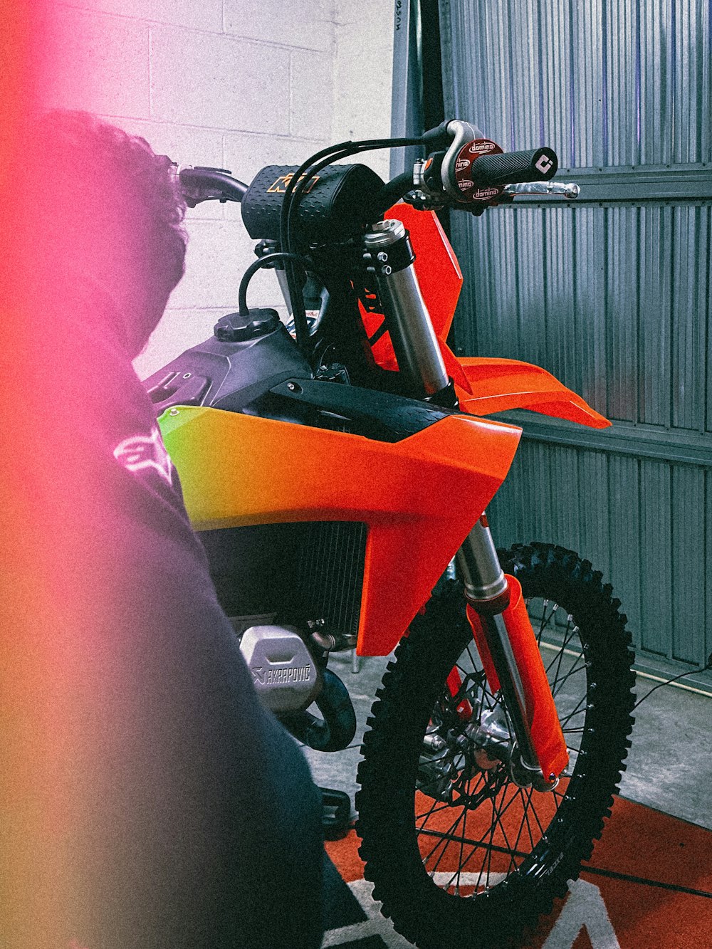 a motorcycle parked inside of a garage next to a wall