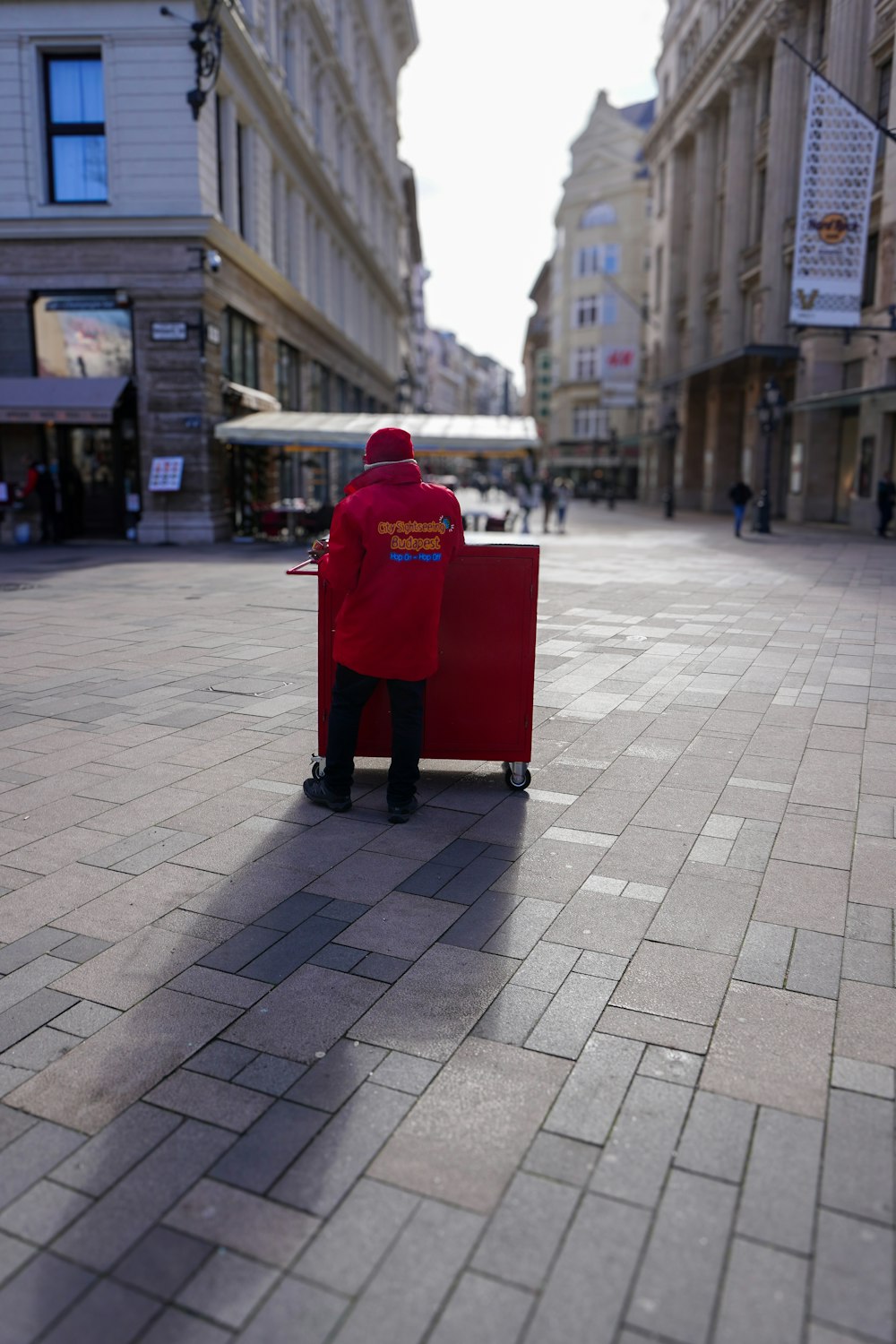 a person in a red coat sitting on a red chair