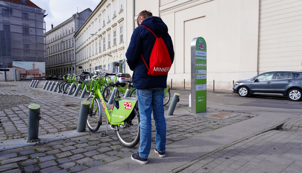 a man standing next to a row of parked bikes