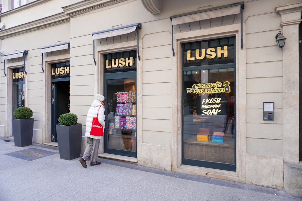 a store front with a person walking by it