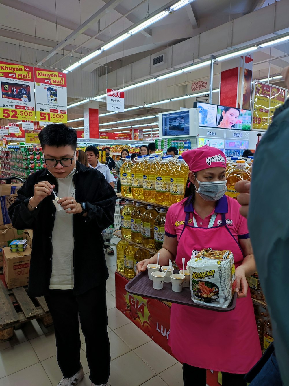 a man wearing a face mask while standing next to a woman in a store