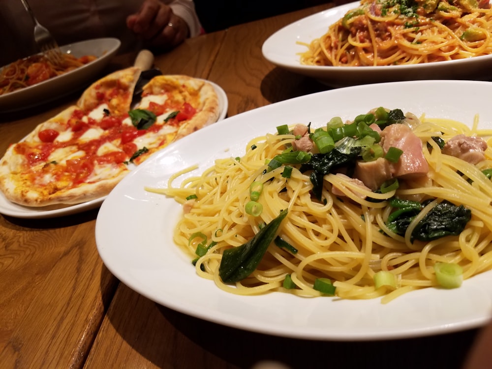 a plate of spaghetti with meat and vegetables