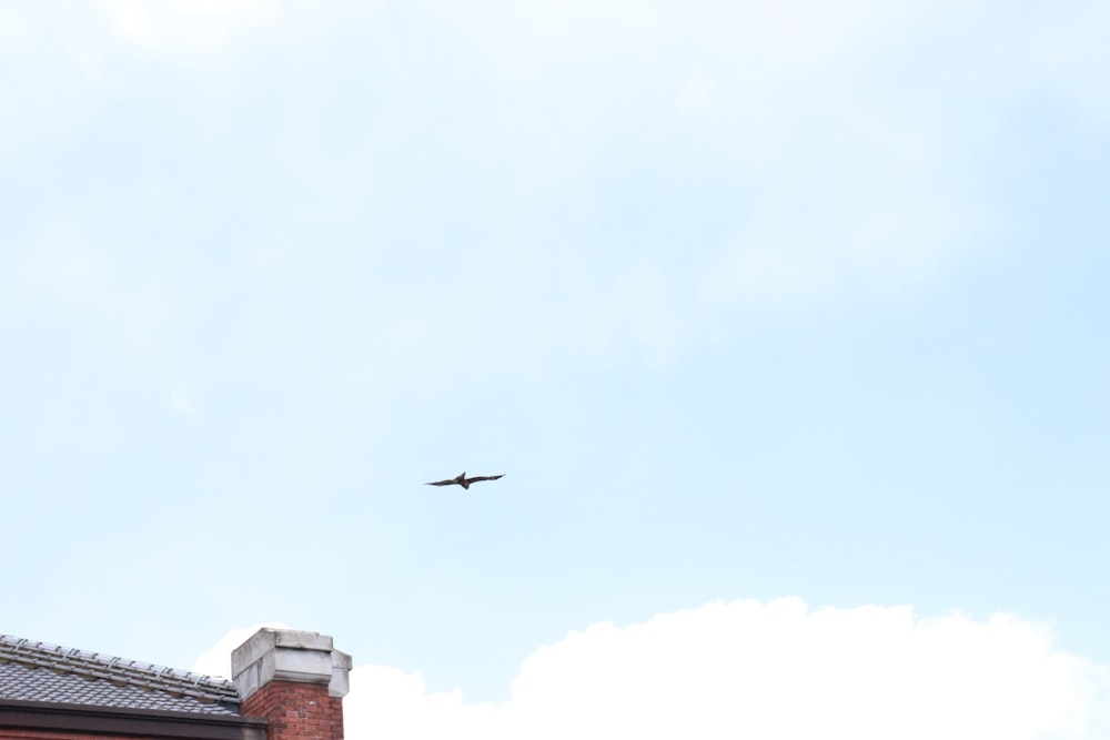 an airplane is flying over a brick building