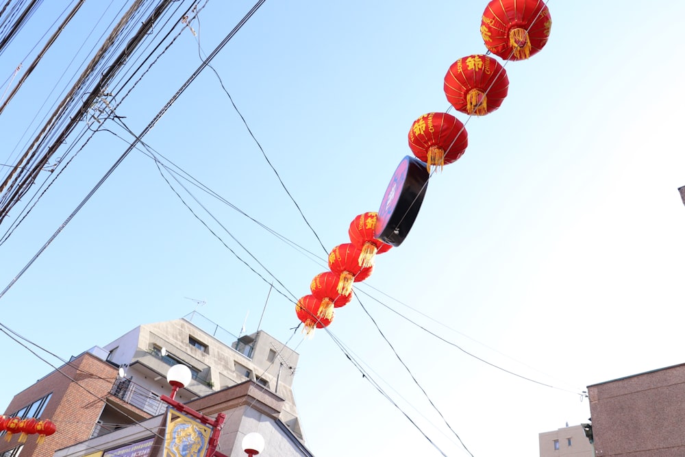 a row of red and yellow lanterns hanging from wires