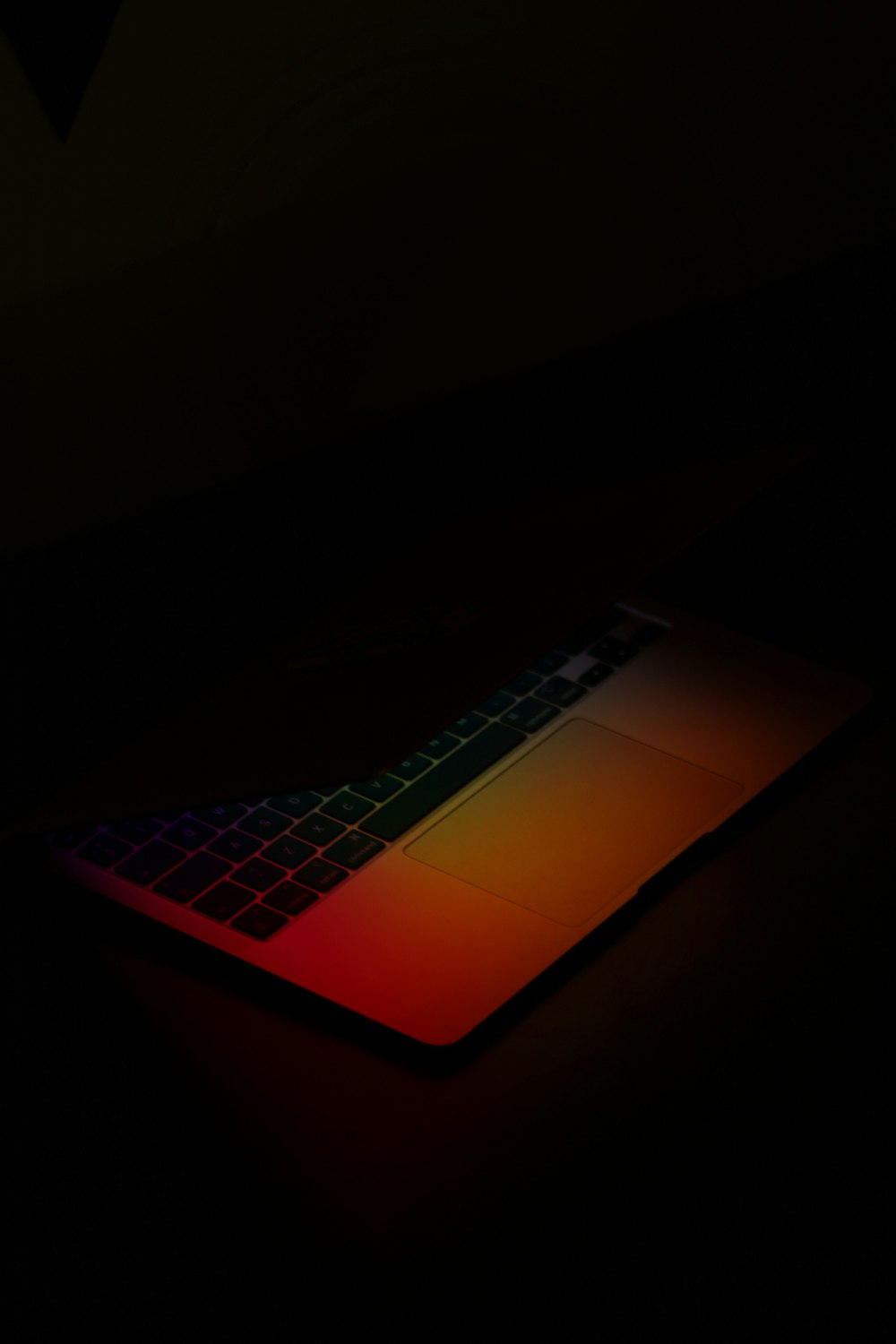 a computer keyboard lit up in the dark