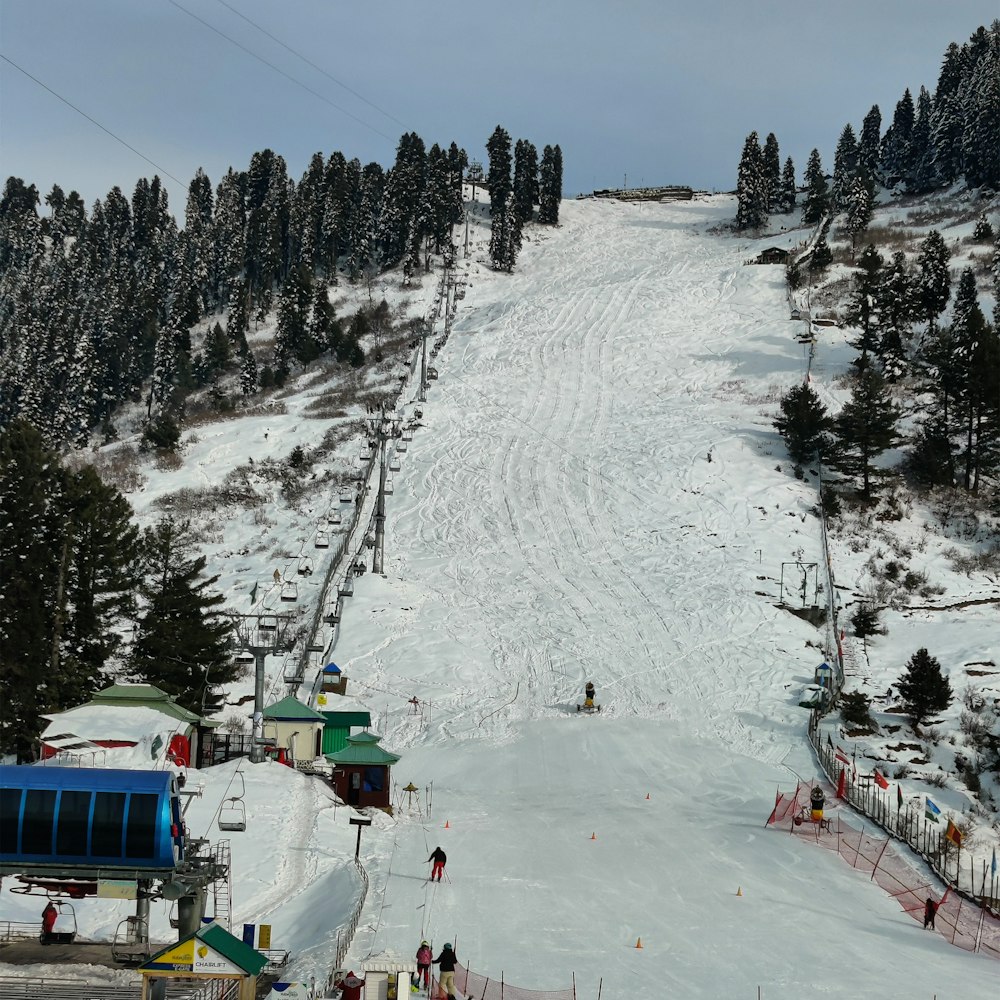 a ski slope with people skiing down it