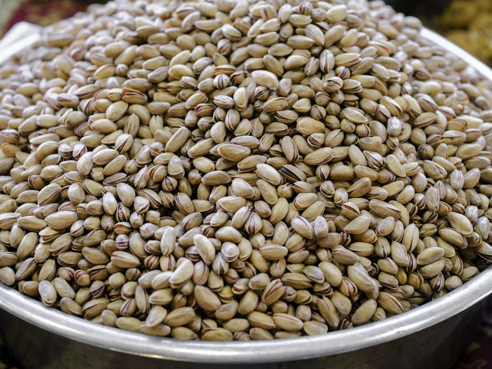 a metal bowl filled with lots of seeds