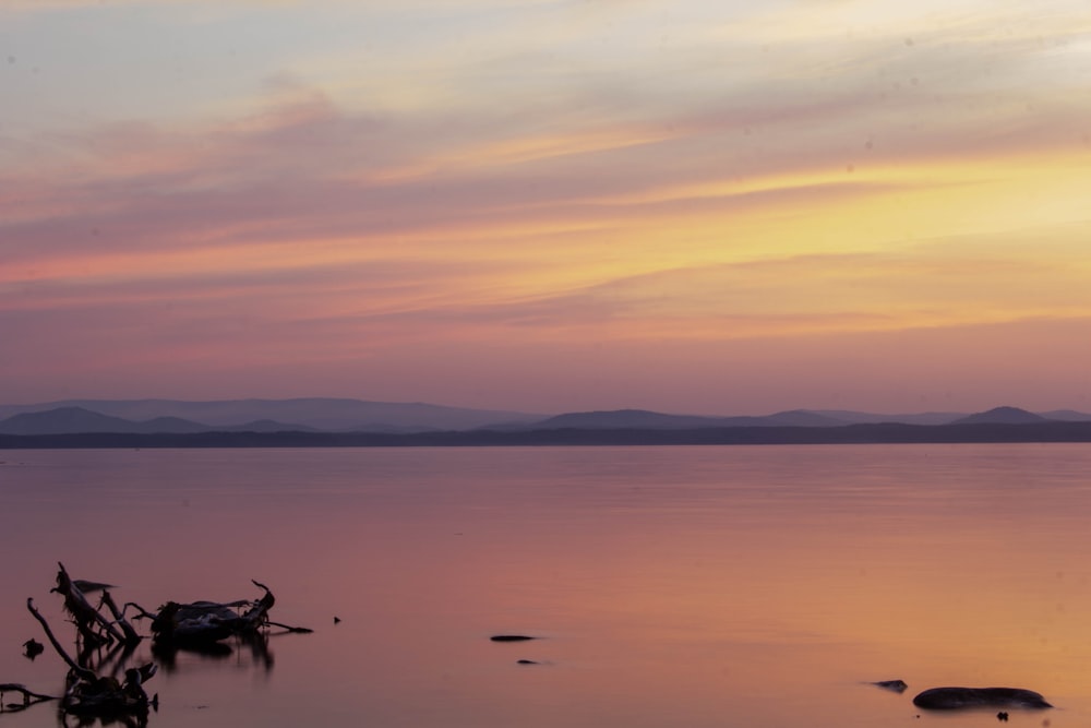 a large body of water sitting under a cloudy sky