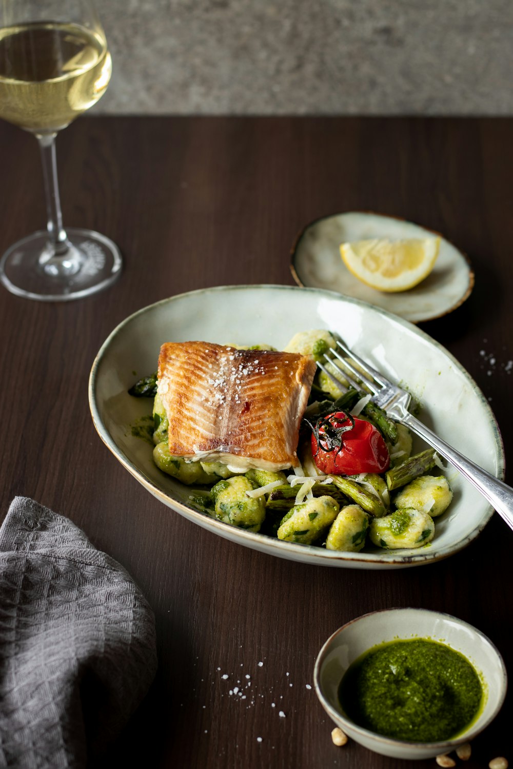 a plate of food and a glass of wine on a table