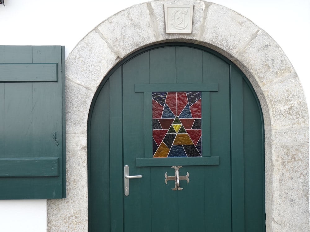 a green door with a stained glass window