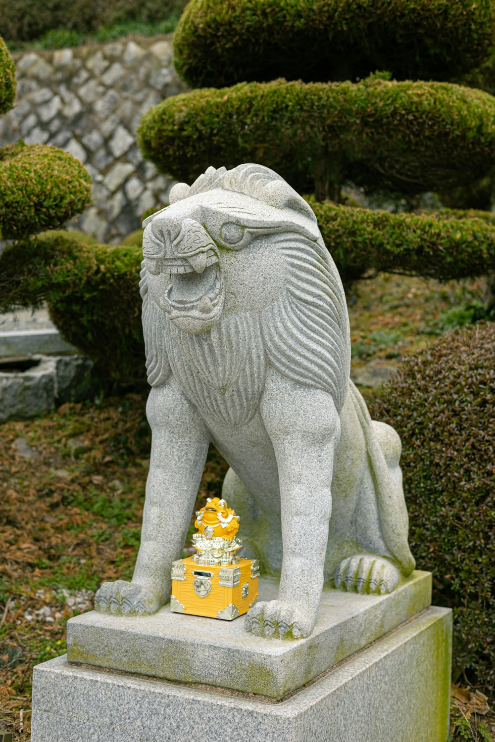 a statue of a lion in a garden