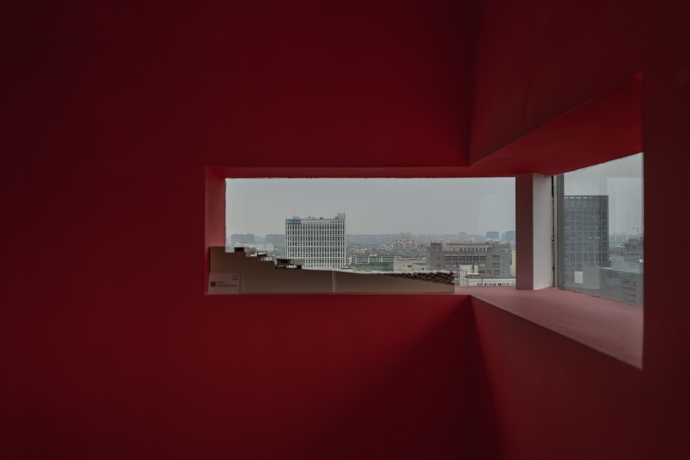 a red room with a view of a city