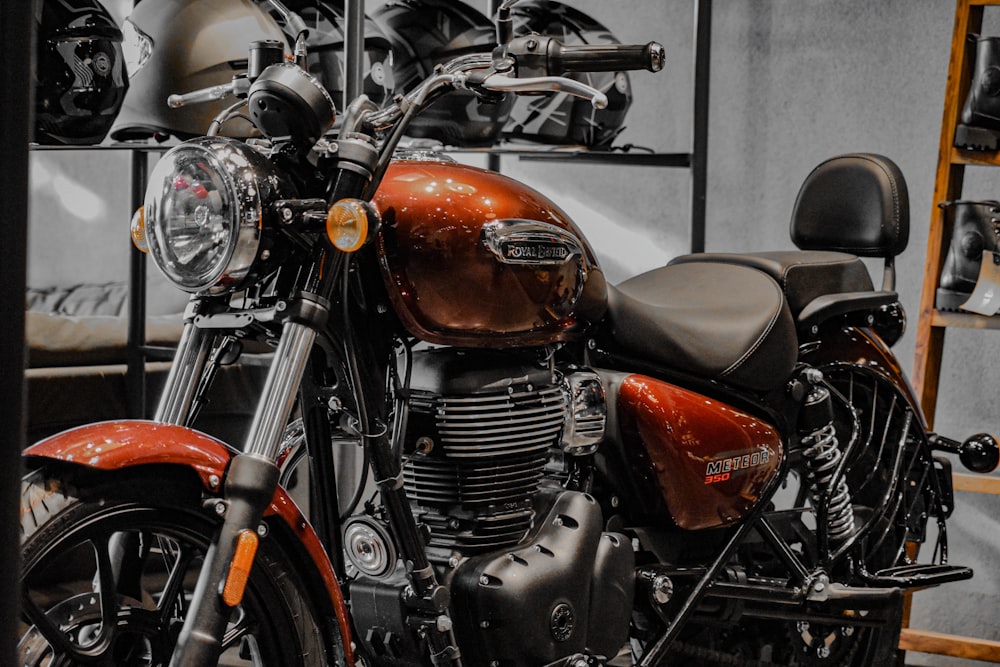 a red motorcycle parked in a garage next to a shelf