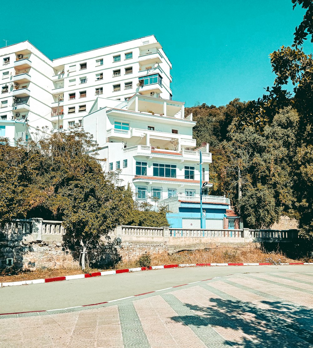 a large white building sitting on the side of a road