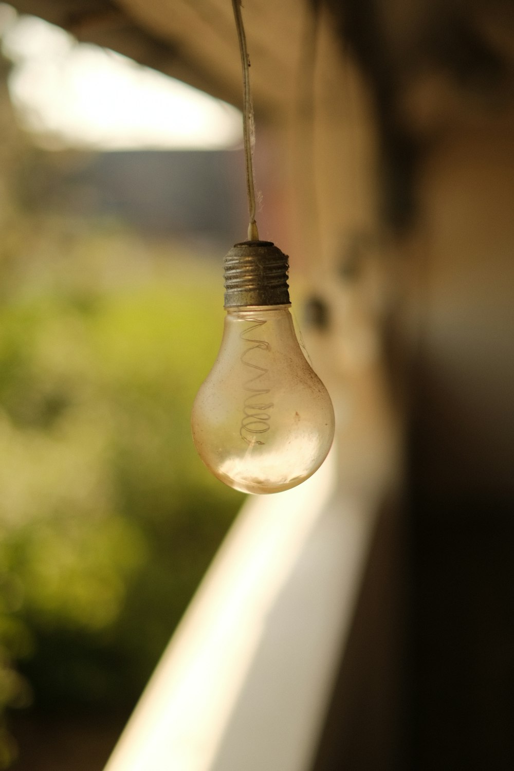 a light bulb hanging from the side of a building