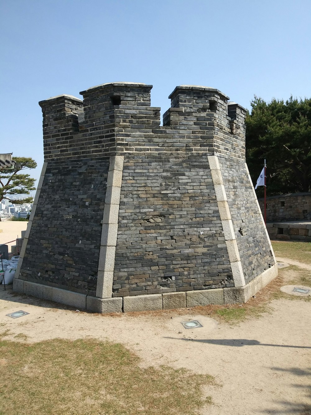 a stone wall with two towers on top of it