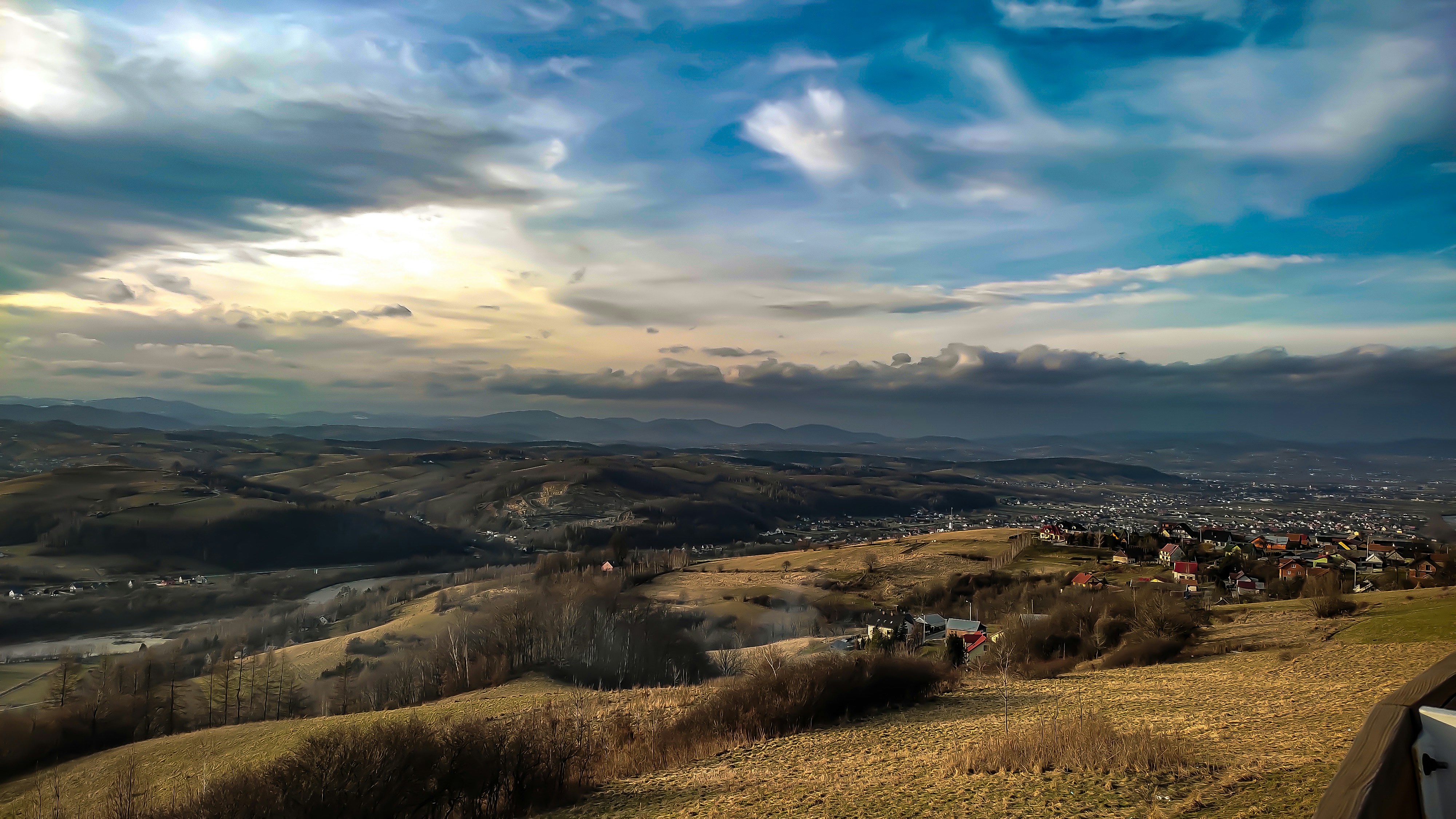 a scenic view of a city from a hill