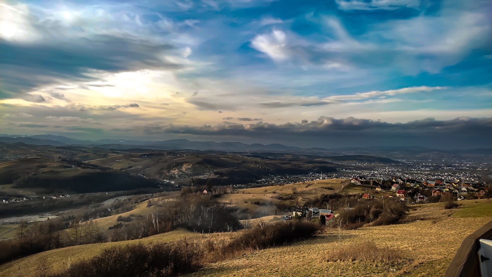 a scenic view of a city from a hill