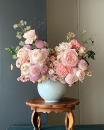 a blue vase filled with pink and white flowers