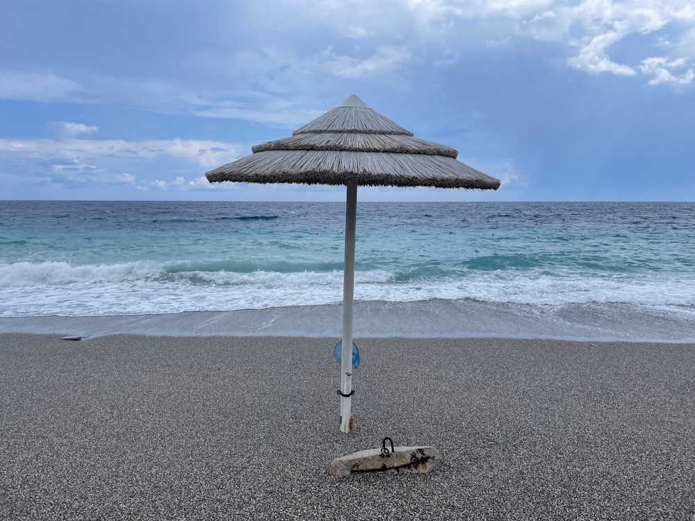 an umbrella on a beach near the ocean