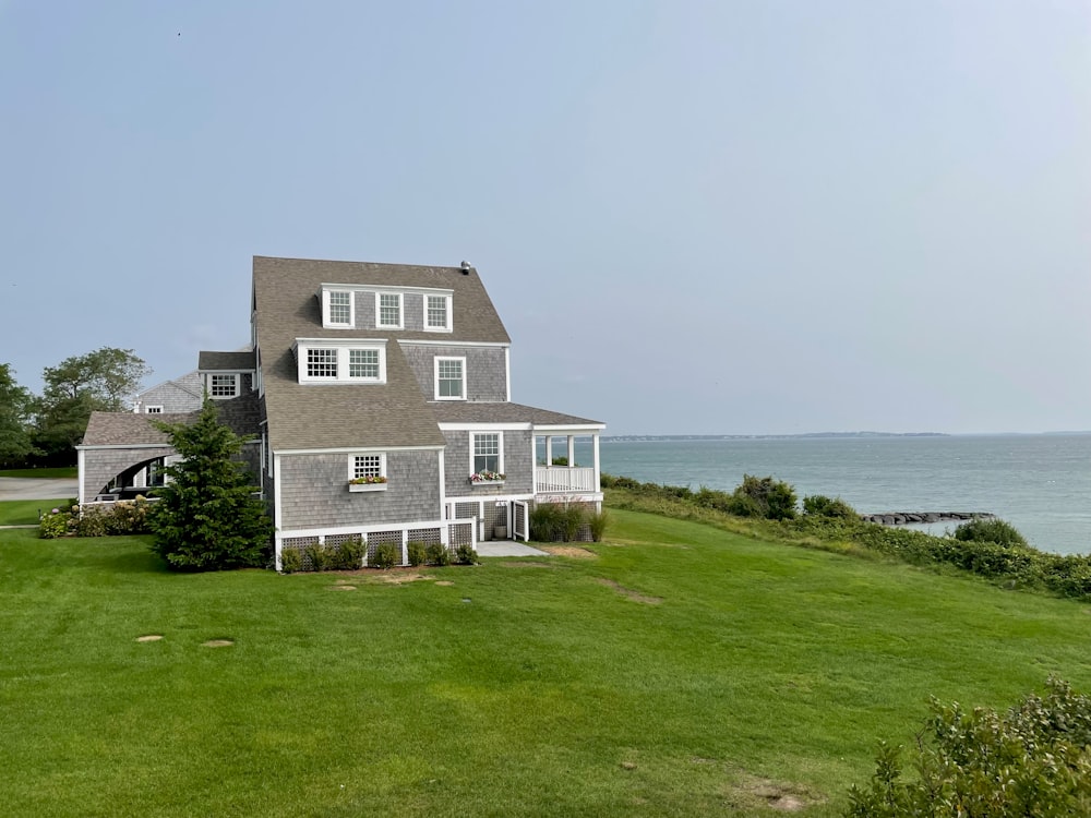 a large house sitting on top of a lush green field