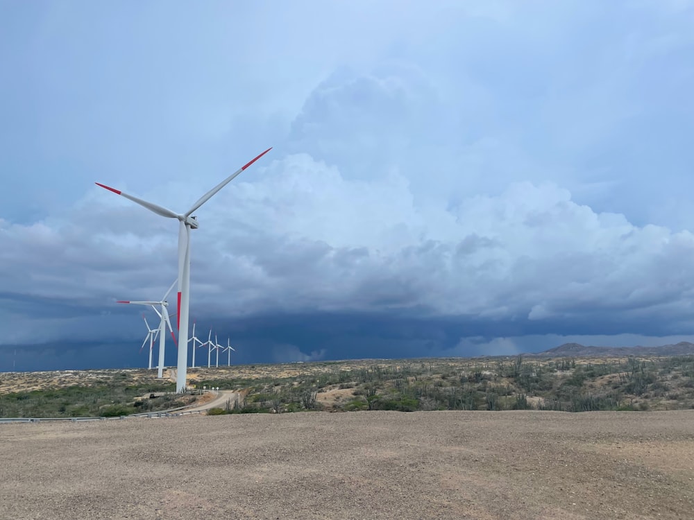 a wind turbine on a dirt road in the desert