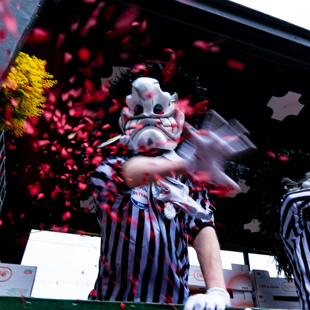 a man wearing a mask and holding a cell phone