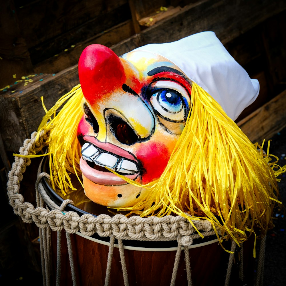 a close up of a clown mask in a bucket