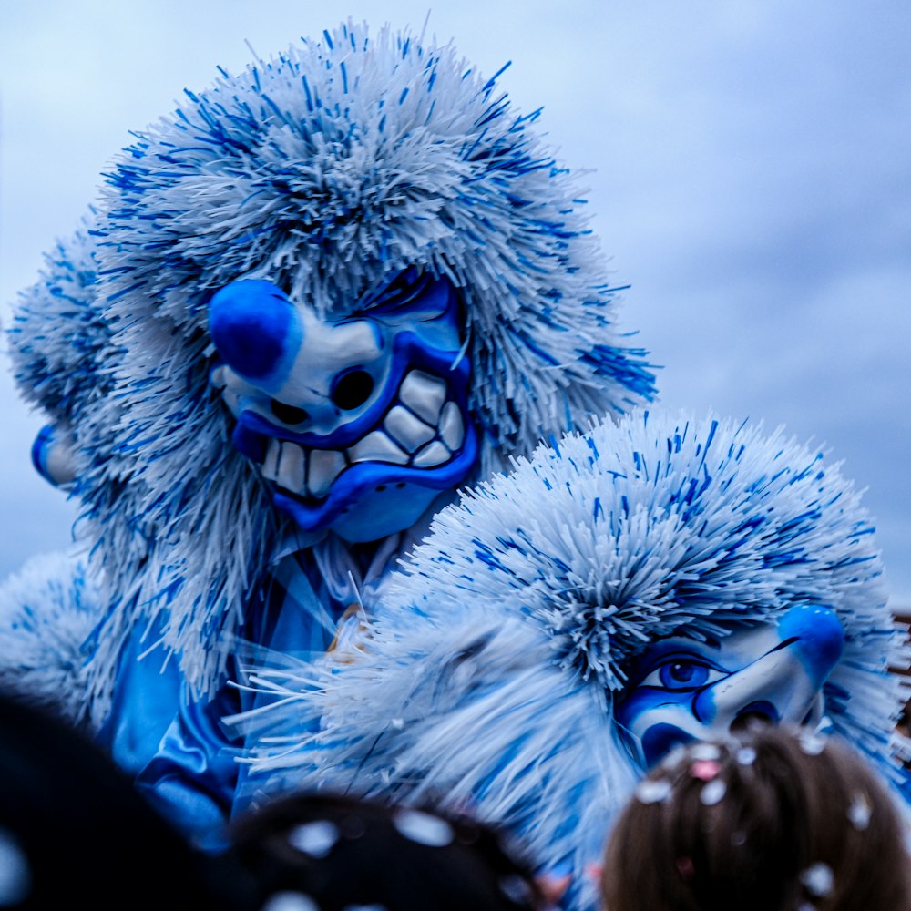 a group of people in blue and white costumes