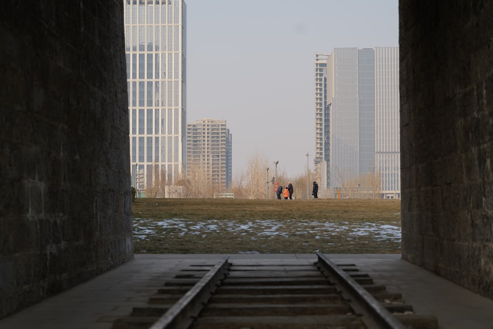 a train track going through a tunnel in a city