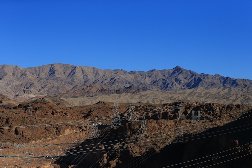 a view of a mountain range with power lines in the foreground